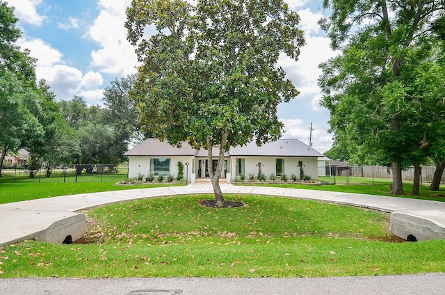36615 Maverick Rd, Simonton, TX 77485 - view of front of property featuring curved driveway, stucco siding, and metal roof