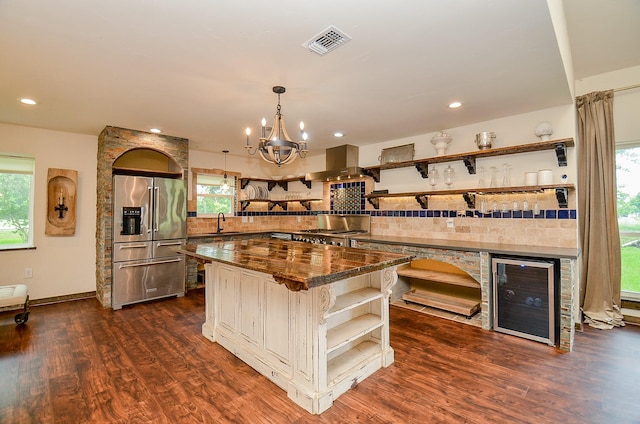 36615 Maverick Rd, Simonton, TX 77485 - kitchen with open shelves, high end fridge, wine cooler, island range hood, and a chandelier