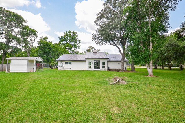 36615 Maverick Rd, Simonton, TX 77485 - rear view of property with an outdoor structure and a chimney