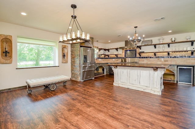 36615 Maverick Rd, Simonton, TX 77485 - kitchen featuring high end fridge, a chandelier, backsplash, a breakfast bar, and dark wood-style floors