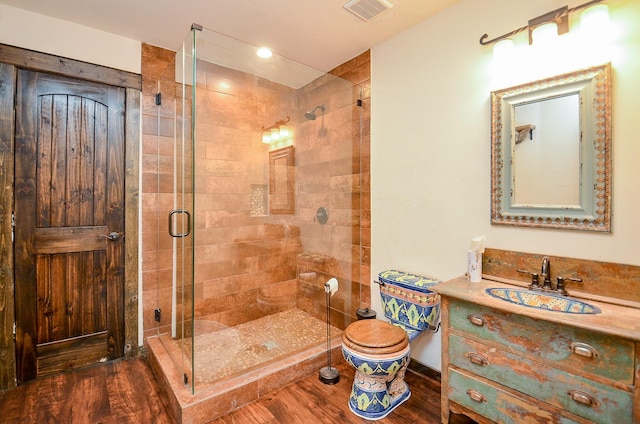 36615 Maverick Rd, Simonton, TX 77485 - full bathroom featuring wood finished floors, a shower stall, vanity, and toilet