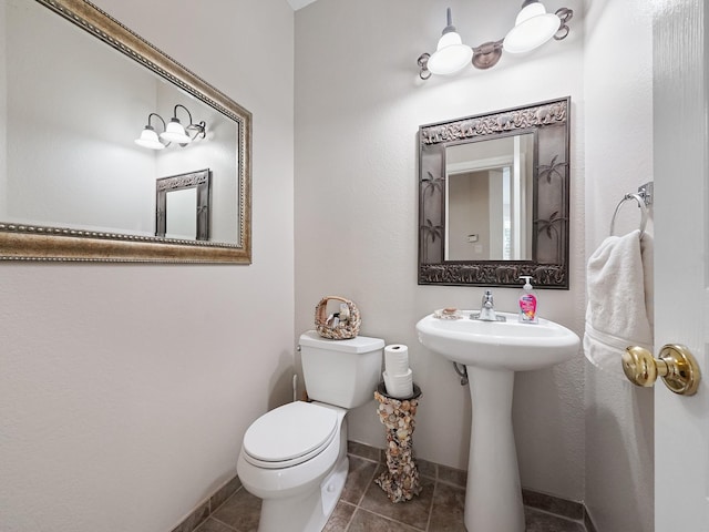 23647 Litchfield Bend Ln, Katy, TX 77494 - half bathroom with toilet, tile patterned floors, baseboards, and a sink