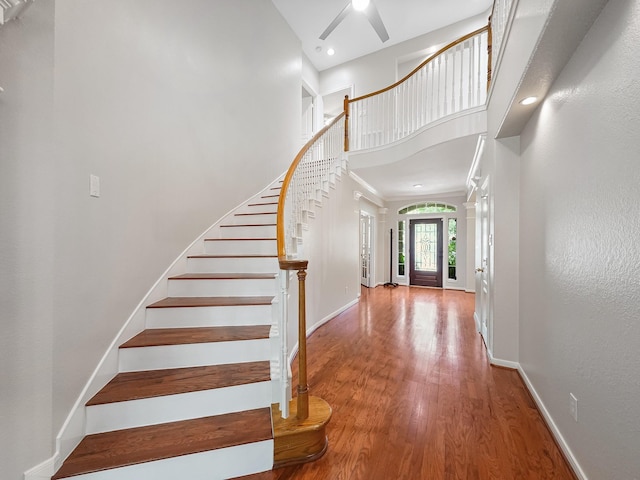 23647 Litchfield Bend Ln, Katy, TX 77494 - entrance foyer with wood finished floors, a towering ceiling, stairway, baseboards, and a ceiling fan