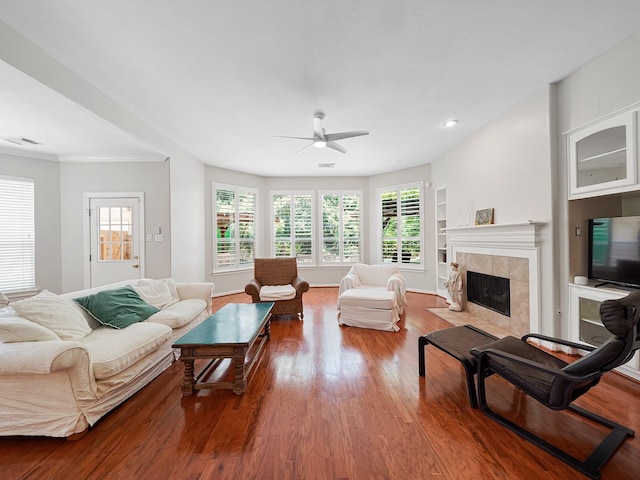 23647 Litchfield Bend Ln, Katy, TX 77494 - living room featuring a ceiling fan, wood finished floors, a tiled fireplace, and recessed lighting