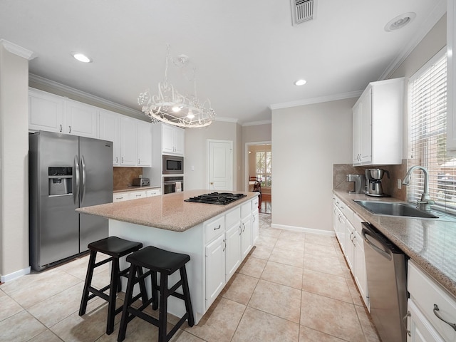 23647 Litchfield Bend Ln, Katy, TX 77494 - kitchen featuring appliances with stainless steel finishes, a sink, a center island, backsplash, and white cabinetry