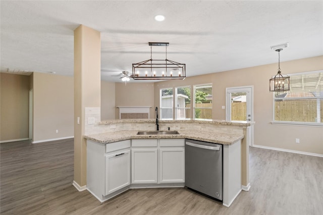 5410 Thyme Ln, Baytown, TX 77521 - kitchen with a sink, dishwasher, a chandelier, light wood finished floors, and white cabinets