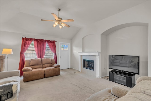 11823 Lois Ln, Pinehurst, TX 77362 - carpeted living area featuring lofted ceiling, a fireplace, ceiling fan, and baseboards