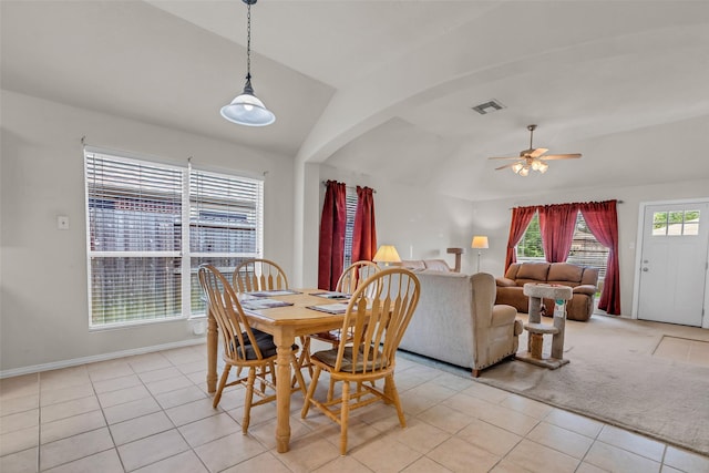11823 Lois Ln, Pinehurst, TX 77362 - dining area featuring vaulted ceiling, ceiling fan, light tile patterned floors, arched walkways, and baseboards