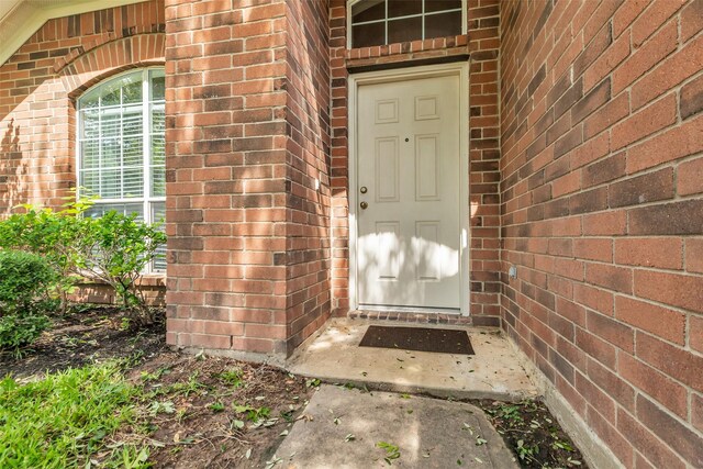 11823 Lois Ln, Pinehurst, TX 77362 - view of exterior entry featuring brick siding