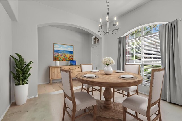 11823 Lois Ln, Pinehurst, TX 77362 - dining space featuring arched walkways, a chandelier, and baseboards