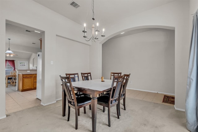 11823 Lois Ln, Pinehurst, TX 77362 - dining space with arched walkways, light carpet, light tile patterned flooring, baseboards, and vaulted ceiling