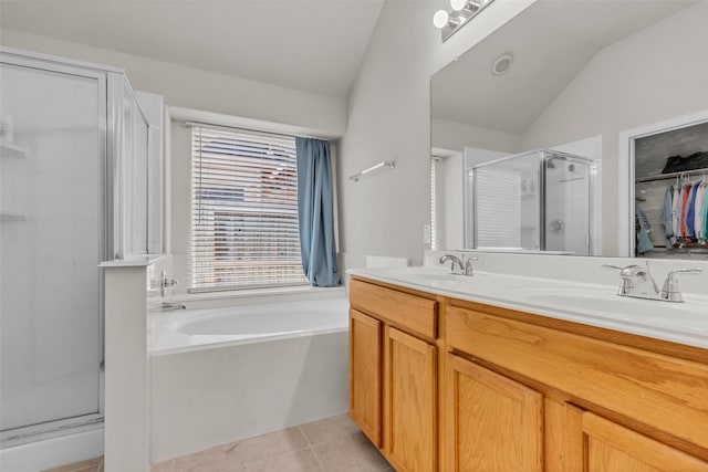 11823 Lois Ln, Pinehurst, TX 77362 - full bathroom featuring a stall shower, lofted ceiling, a bath, double vanity, and tile patterned floors
