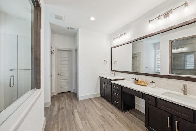 1685 Daylight Lake Dr, Katy, TX 77493 - bathroom featuring double vanity, wood finished floors, a stall shower, baseboards, and recessed lighting