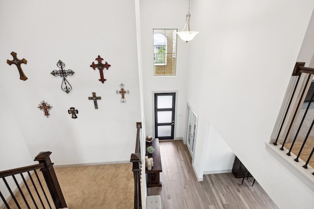 1685 Daylight Lake Dr, Katy, TX 77493 - foyer entrance with stairs, a towering ceiling, light wood finished floors, and baseboards
