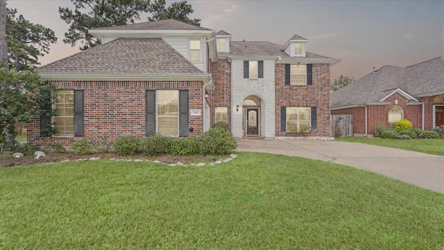 19603 Pitchstone Dr, Tomball, TX 77377 - traditional home with a lawn, brick siding, driveway, and roof with shingles