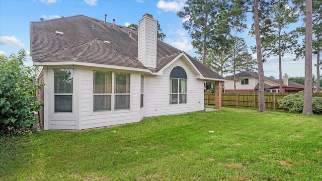 19603 Pitchstone Dr, Tomball, TX 77377 - back of house with roof with shingles and a chimney
