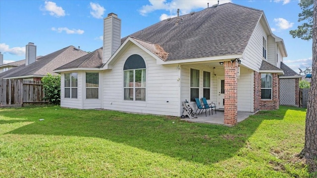 19603 Pitchstone Dr, Tomball, TX 77377 - back of house with a patio, brick siding, a shingled roof, and a chimney