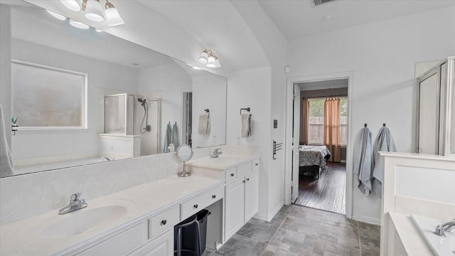 19603 Pitchstone Dr, Tomball, TX 77377 - bathroom featuring a shower stall, a garden tub, ensuite bathroom, double vanity, and baseboards
