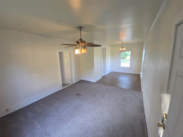 301 Harold St, Crockett, TX 75835 - empty room featuring dark colored carpet, baseboards, a ceiling fan, and a chandelier