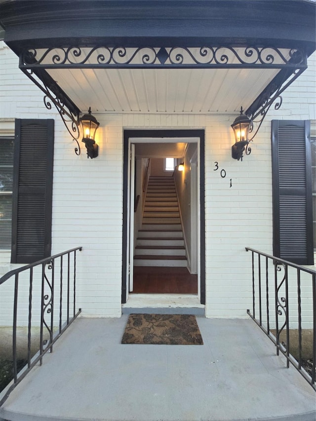 301 Harold St, Crockett, TX 75835 - doorway to property featuring brick siding and covered porch