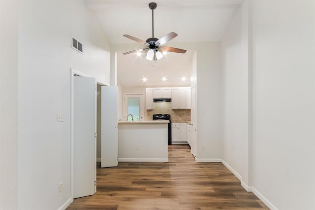 12626 Marble Dr, Houston, TX 77070 - unfurnished living room featuring vaulted ceiling, a ceiling fan, wood finished floors, baseboards, and a sink