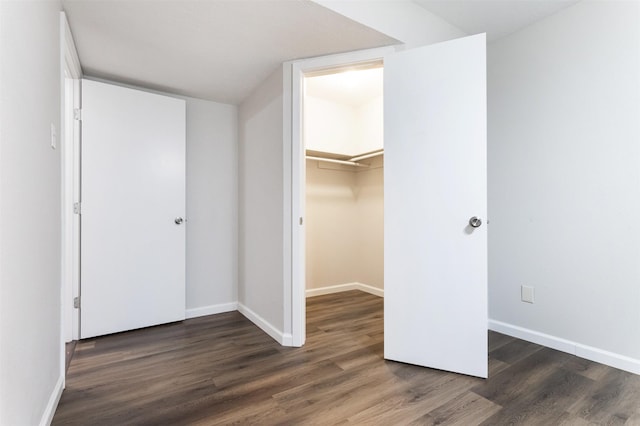 12626 Marble Dr, Houston, TX 77070 - unfurnished bedroom featuring wood finished floors, baseboards, and a walk in closet