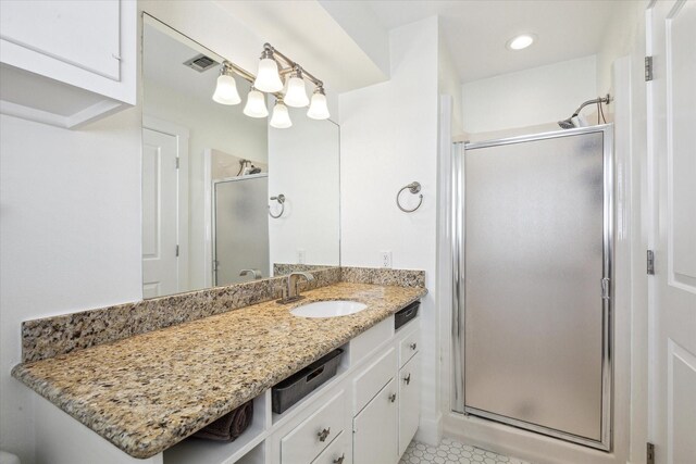 3411 Petite Cir, Galveston, TX 77554 - bathroom featuring a stall shower, vanity, tile patterned floors, and recessed lighting