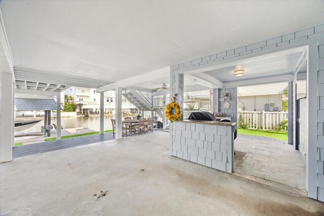 3411 Petite Cir, Galveston, TX 77554 - garage featuring a water view and ceiling fan