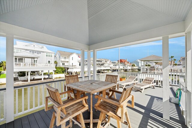 3411 Petite Cir, Galveston, TX 77554 - wooden deck with a water view, a residential view, and outdoor dining space