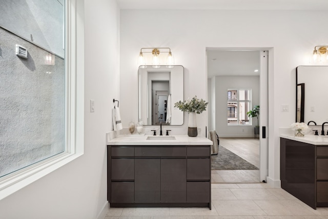 4309 Floyd St Unit B, Houston, TX 77007 - full bathroom featuring two vanities, tile patterned flooring, and baseboards