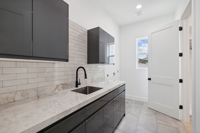 4309 Floyd St Unit B, Houston, TX 77007 - kitchen featuring a sink, gray cabinets, tasteful backsplash, and baseboards