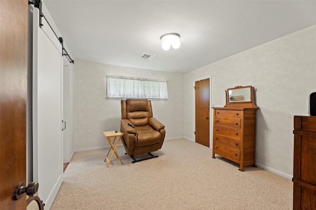 613 Bolling Green Dr, Wharton, TX 77488 - living area featuring a barn door, carpet, and baseboards