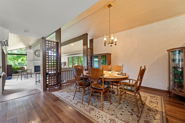 613 Bolling Green Dr, Wharton, TX 77488 - dining room with hardwood / wood-style flooring, healthy amount of natural light, wallpapered walls, and a chandelier