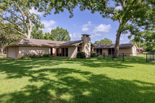 613 Bolling Green Dr, Wharton, TX 77488 - back of property featuring a chimney and a garage