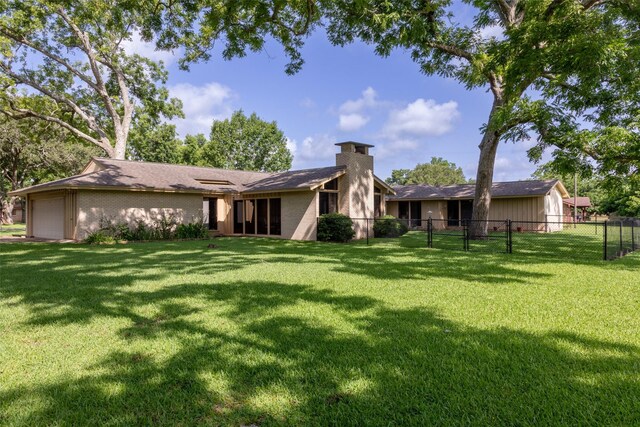 613 Bolling Green Dr, Wharton, TX 77488 - back of house featuring a chimney and a garage