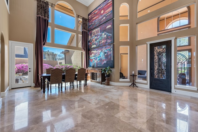 15818 Conners Ace Dr, Spring, TX 77379 - entryway with a towering ceiling, marble tiled flooring, baseboards, and ornamental molding