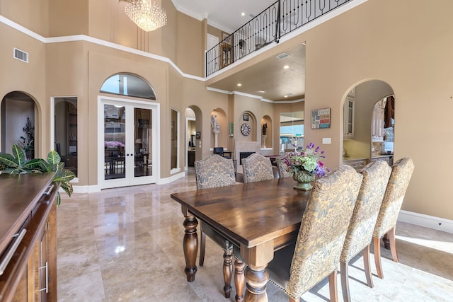 15818 Conners Ace Dr, Spring, TX 77379 - dining space featuring a high ceiling, ornamental molding, arched walkways, baseboards, and light marble finish floors