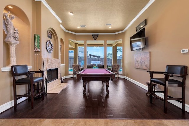 15818 Conners Ace Dr, Spring, TX 77379 - playroom featuring ornamental molding, billiards table, a tiled fireplace, wood finished floors, and baseboards