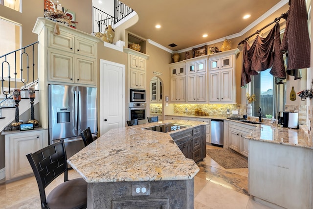 15818 Conners Ace Dr, Spring, TX 77379 - kitchen with stainless steel appliances, crown molding, tasteful backsplash, a kitchen island with sink, and light stone counters