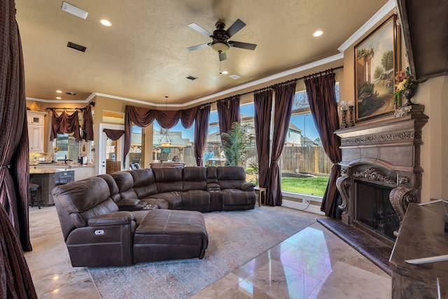 15818 Conners Ace Dr, Spring, TX 77379 - living room with a fireplace with raised hearth, crown molding, light marble finish floors, a ceiling fan, and recessed lighting