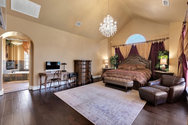 15818 Conners Ace Dr, Spring, TX 77379 - bedroom with arched walkways, dark wood-style flooring, a chandelier, multiple windows, and high vaulted ceiling