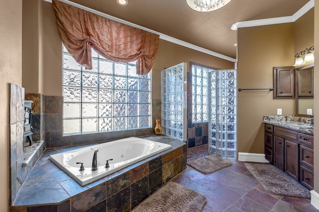 15818 Conners Ace Dr, Spring, TX 77379 - bathroom featuring a tub with jets, vanity, a walk in shower, stone tile floors, and baseboards