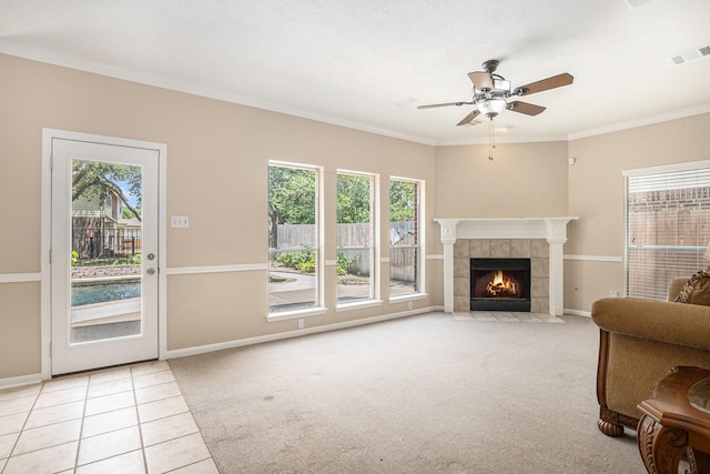 15242 Shapiro Springs Ln, Houston, TX 77095 - tiled living room featuring healthy amount of natural light, a ceiling fan, a fireplace, ornamental molding, and baseboards