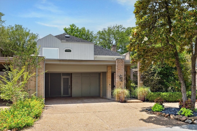 7 Woodstone St, Houston, TX 77024 - traditional-style house featuring brick siding, a shingled roof, concrete driveway, and a garage