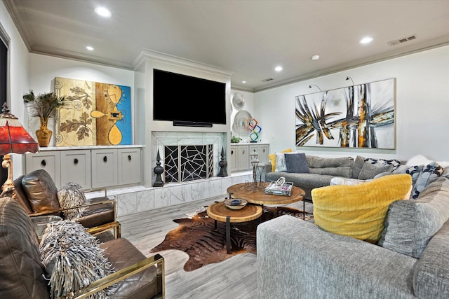 7 Woodstone St, Houston, TX 77024 - living room featuring crown molding, wood finished floors, a premium fireplace, and recessed lighting
