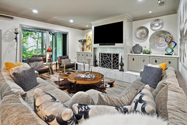 7 Woodstone St, Houston, TX 77024 - living area featuring ornamental molding, wood finished floors, a premium fireplace, and recessed lighting