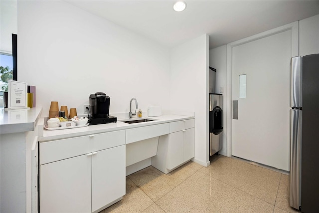 3600 Montrose Blvd Unit 906, Houston, TX 77006 - kitchen featuring freestanding refrigerator, a sink, dark aggregate flooring, light countertops, and white cabinetry