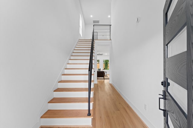 514 Melbourne St Unit B, Houston, TX 77022 - stairs with wood finished floors, baseboards, a towering ceiling, and recessed lighting