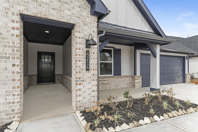 5302 Allen Cay, Texas City, TX 77590 - property entrance with board and batten siding, a porch, driveway, an attached garage, and brick siding