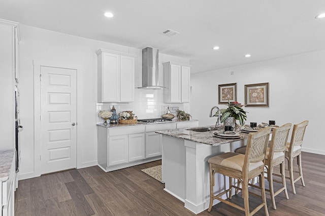 5302 Allen Cay, Texas City, TX 77590 - kitchen with wall chimney range hood, dark wood-type flooring, white cabinetry, a sink, and recessed lighting